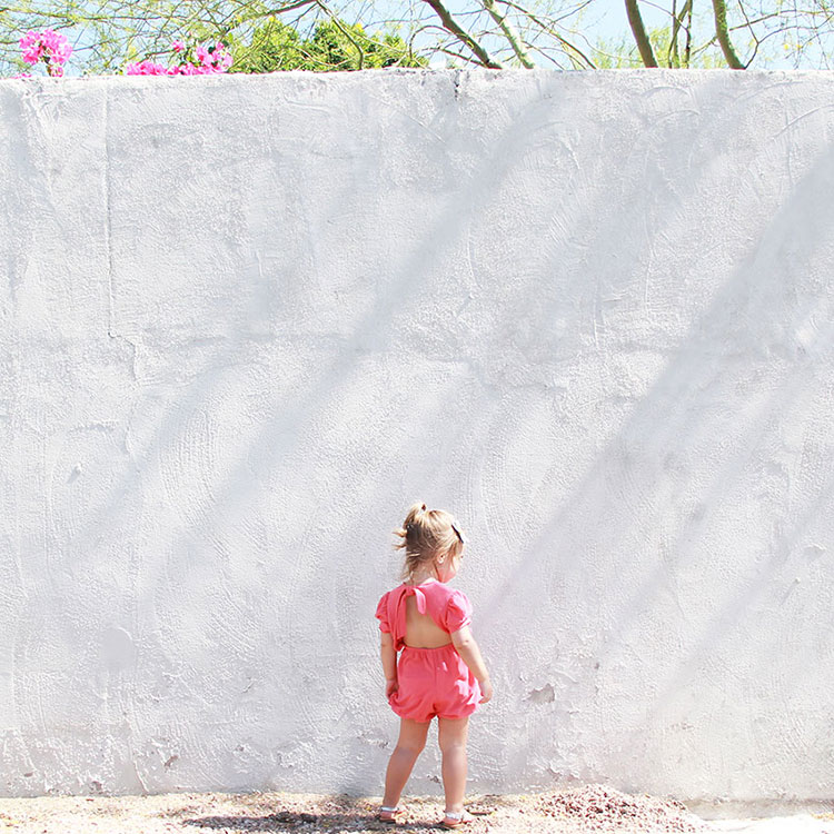 baby girl in crew + lu romper and pitchoun designs bow | the love designed life