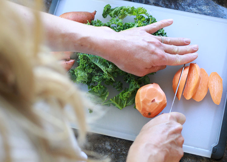 chopping sweet potatoes and kale for homemade babyfood | the love designed life