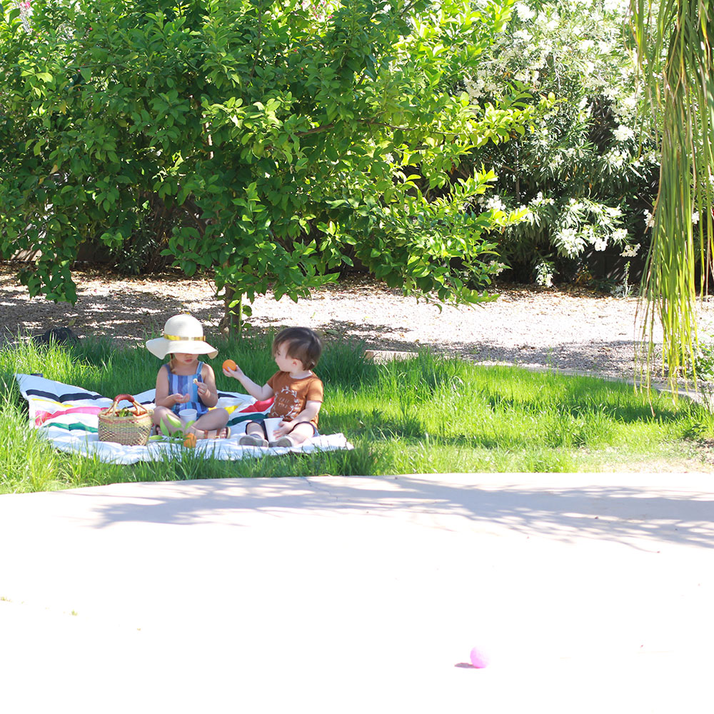 my babies having a little picnic snack in our new backyard. literally a dream come true. | thelovedesignedlife.com