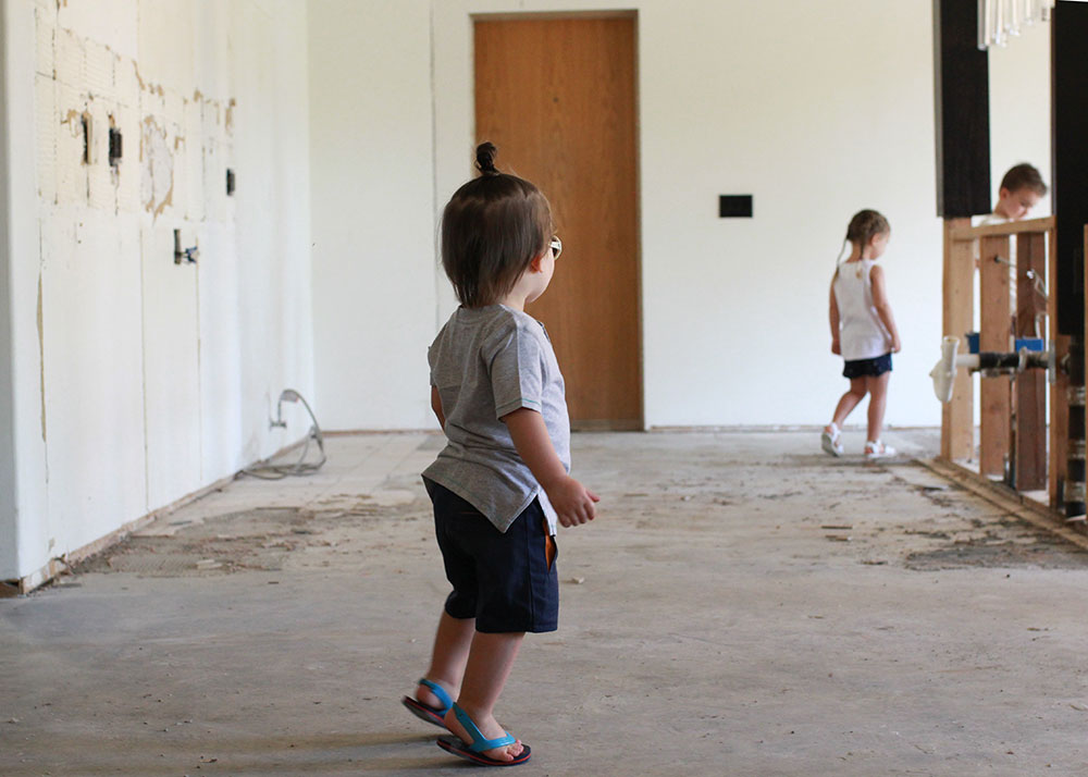 sweet kiddos in the empty kitchen before our renovation | thelovedesginedlife.com