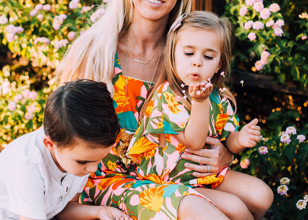 blowing flower petals to make a wish in matching mommy and me outfits | thelovedesignedlife.com