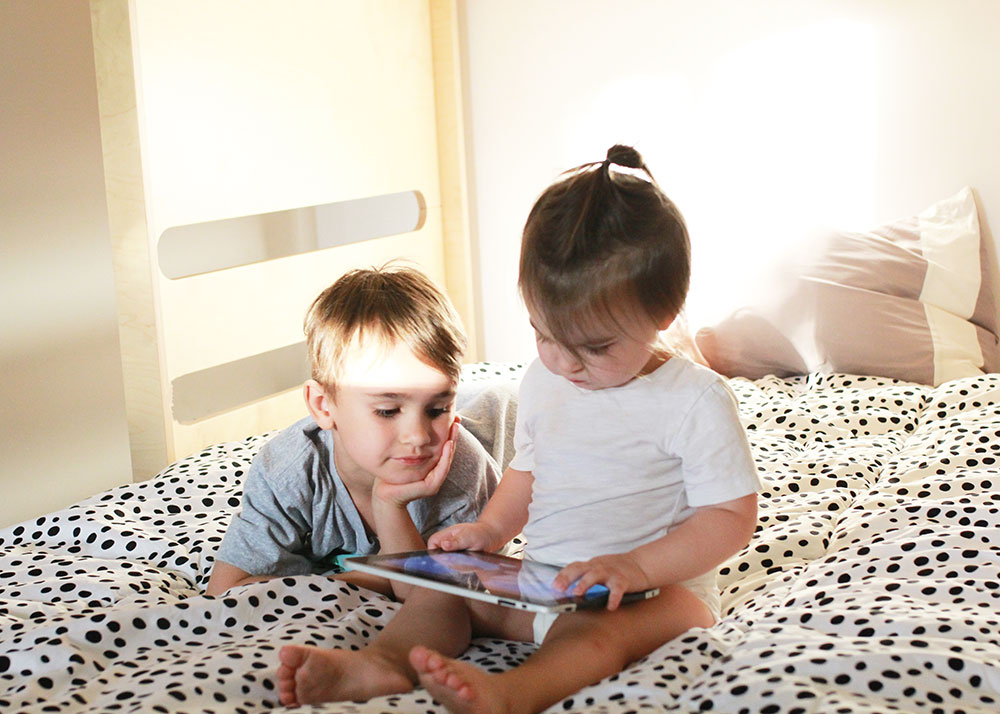 love these brothers watching their ipad in their new bunk beds | thelovedesignedlife.com