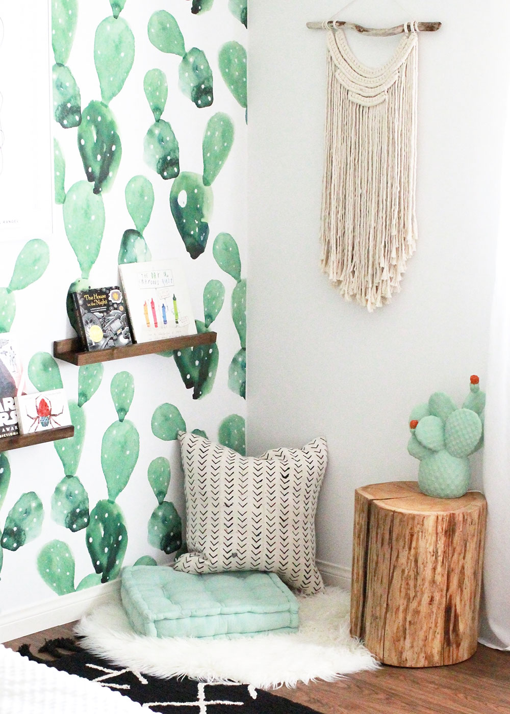 this corner because the perfect spot for a reading nook, with floor pillows, wall shelves, and a fun cactus lamp | thelovedesignedlife.com