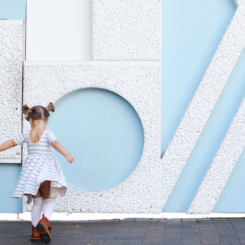 my sweet little girl twirling her way by small world at disneyland | thelovedesignedlife.com