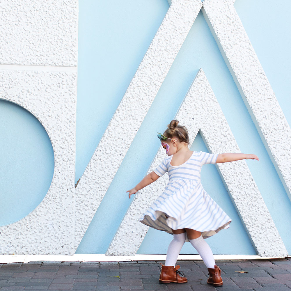 my sweet little girl twirling her way by small world at disneyland | thelovedesignedlife.com