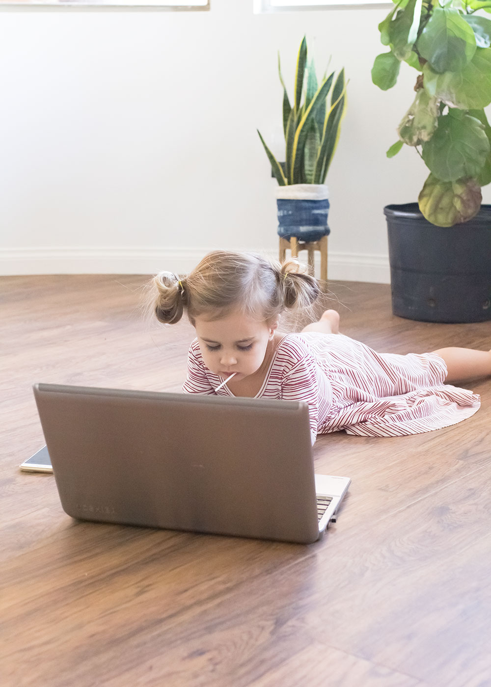 cute little girl on the computer. how to balance motherhood and blogging with the mom blog collective series | thelovedesignedlife.com