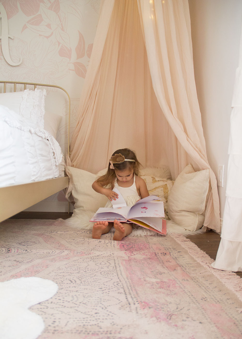 she loves her special little reading nook in her new pink and gold big girl's room | thelovedesignedlife.com