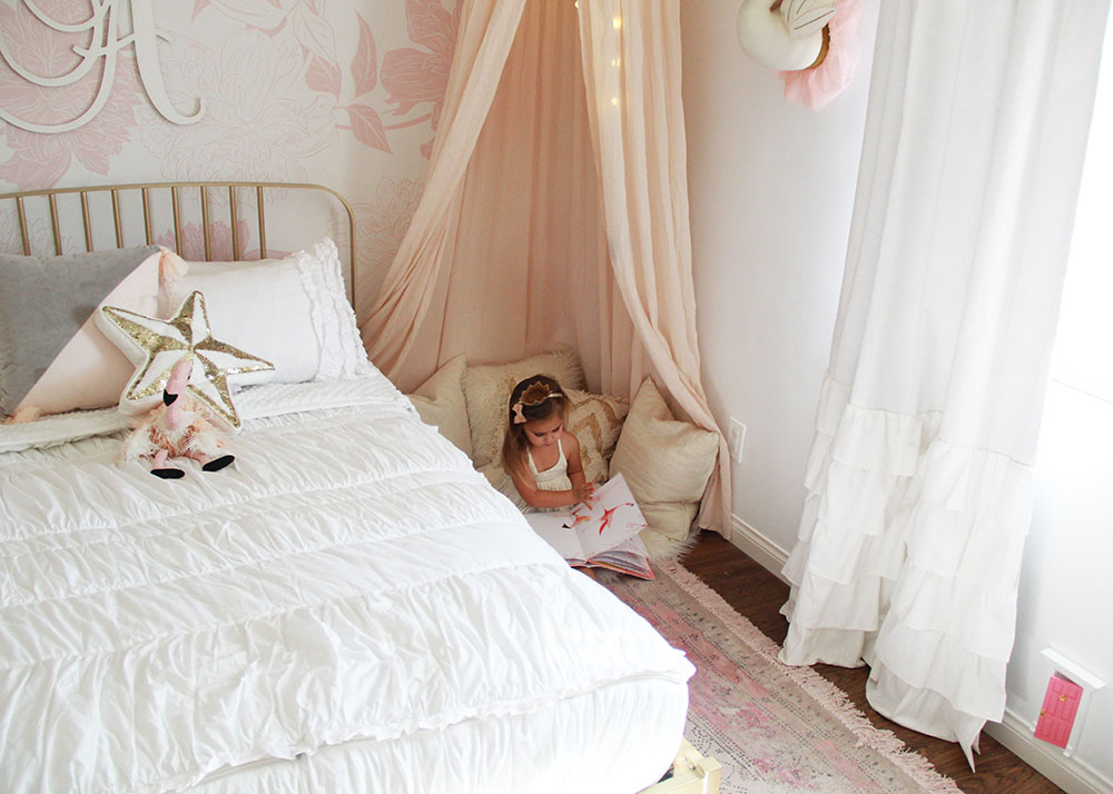 she loves her special little reading nook in her new pink and gold big girl's room | thelovedesignedlife.com