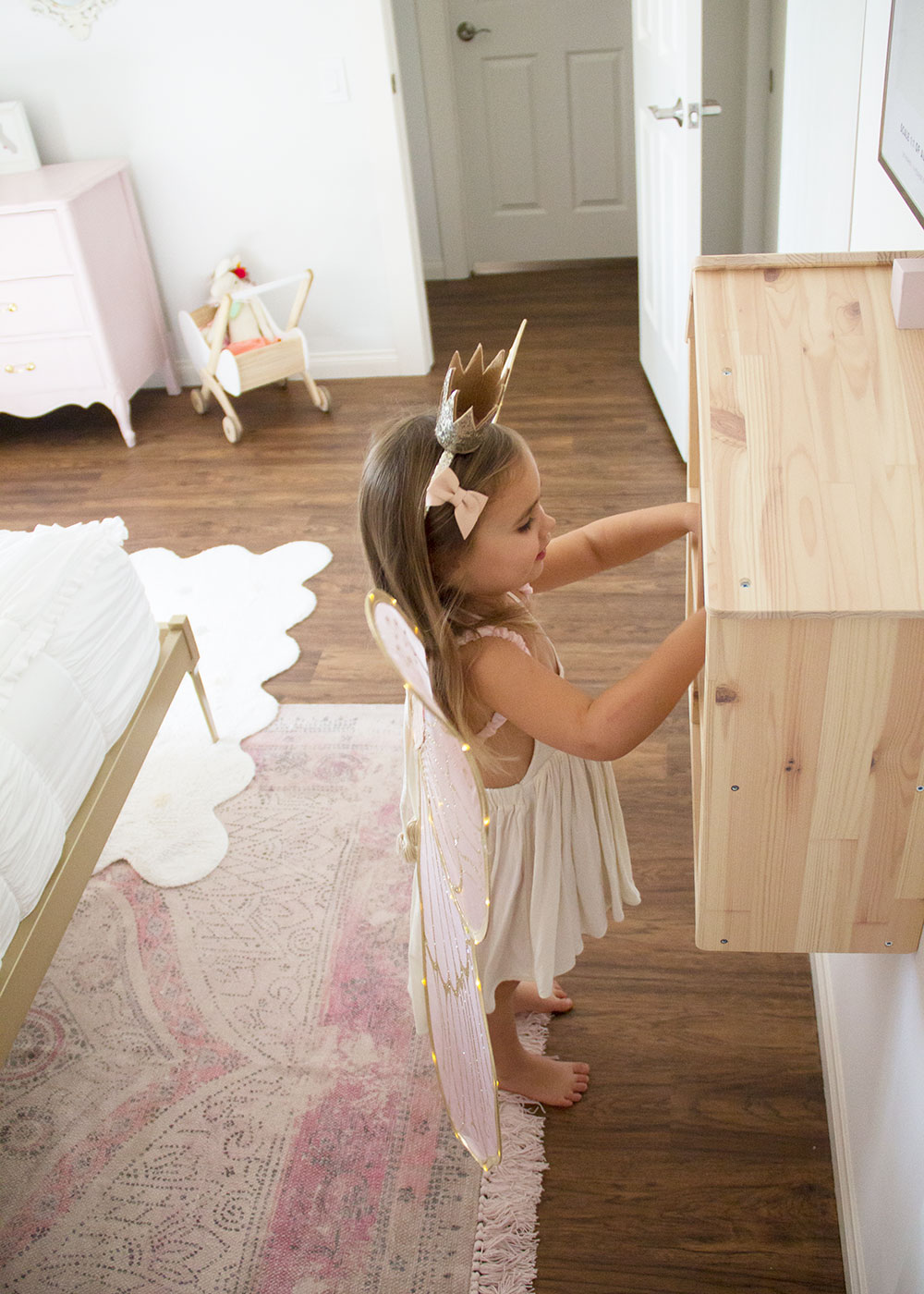 sweet little girl playing with the dollhouse in her new big girl room! | thelovedesignedlife.com