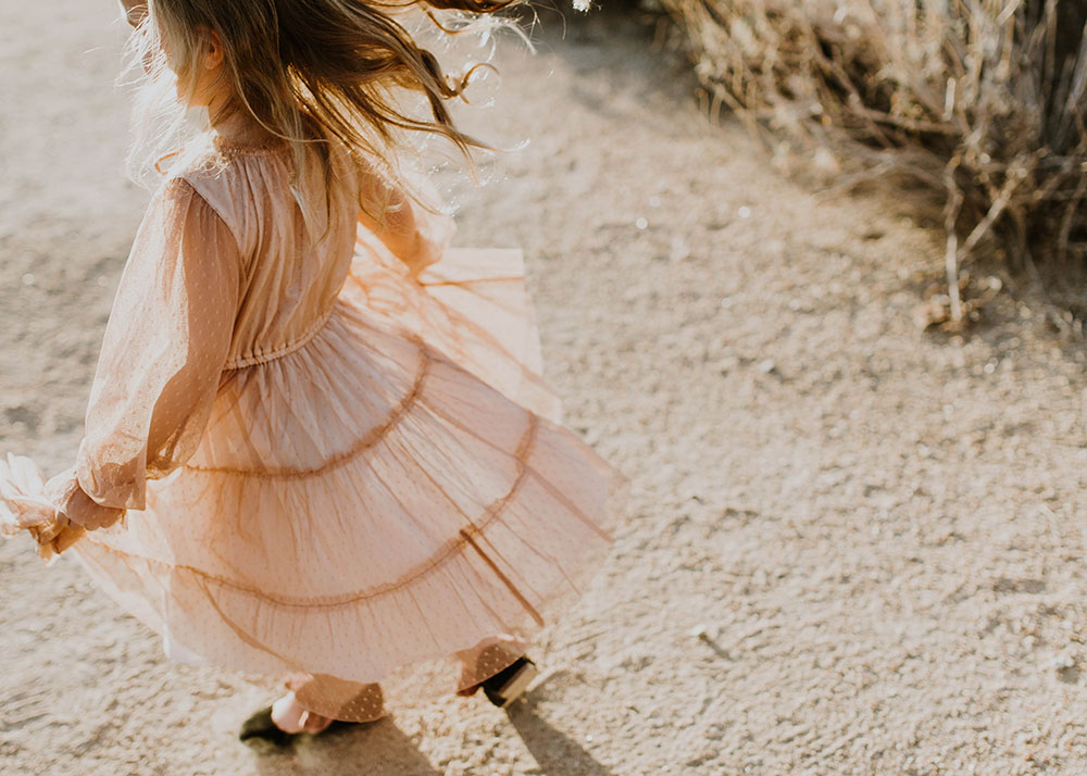 sweet little girl twirling in her pink swiss dot dress #familyphotos | thelovedesignedlife.com