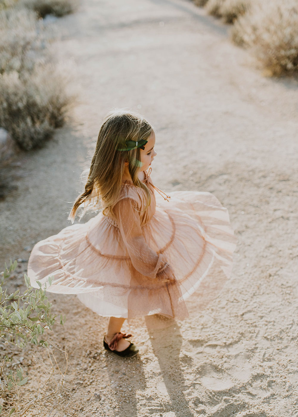 sweet little girl twirling in her pink swiss dot dress #familyphotos | thelovedesignedlife.com