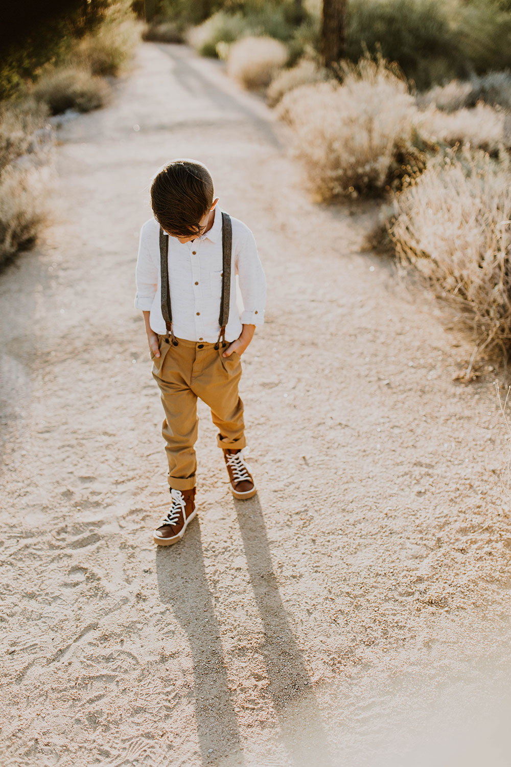 handsome young man in his suspenders #familyphotos #boysclothes #outfitideas | thelovedesignedlife.com