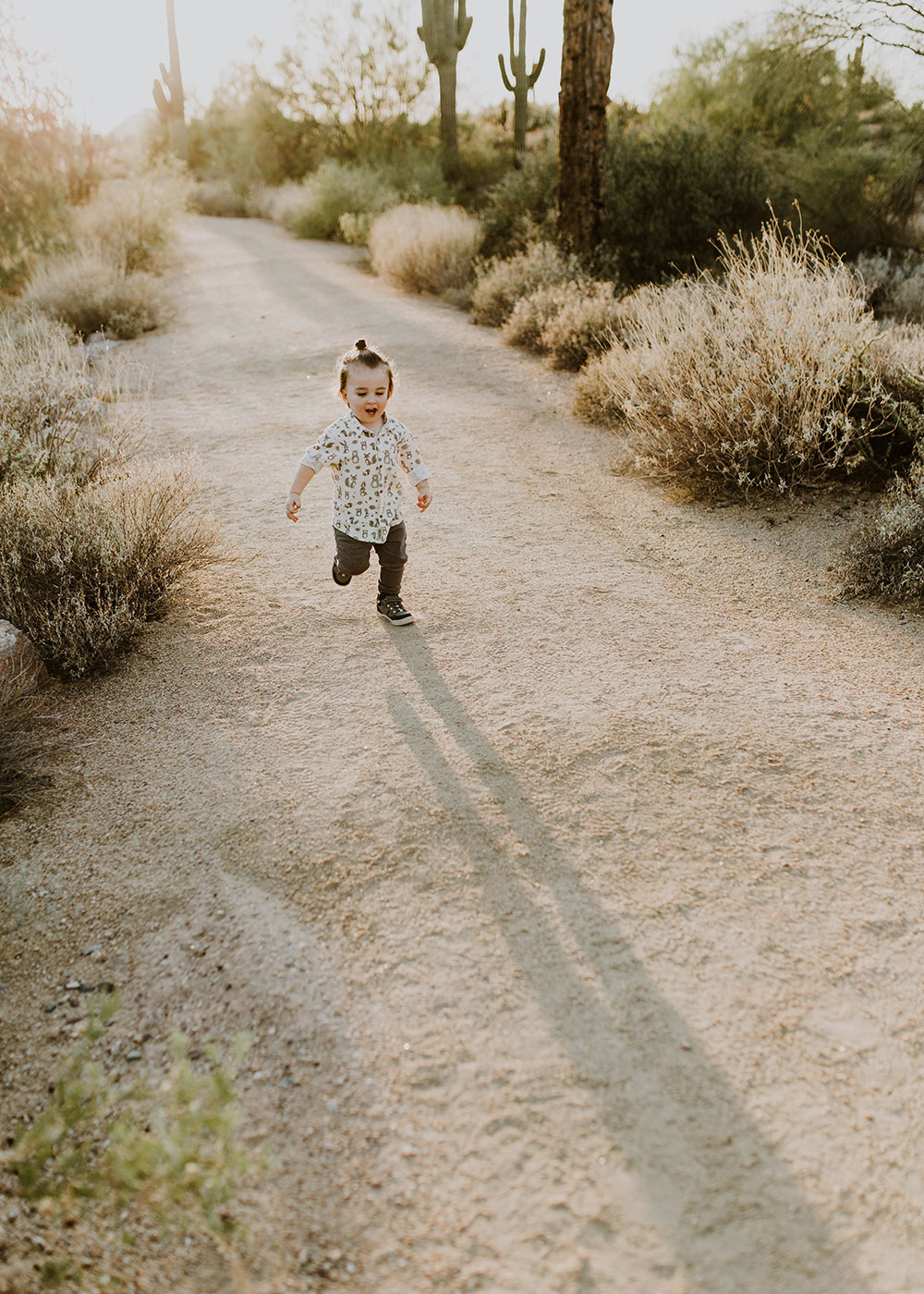 wild toddler running in desert family boho photo session #familyphotos #manbun #boysoutfitideas | thelovedesignedlife.com