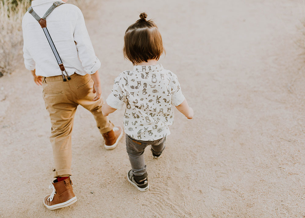 walking in big brother's footsteps. #brothers #familyphotos #boysoutfitideas | thelovedesignedlife.com