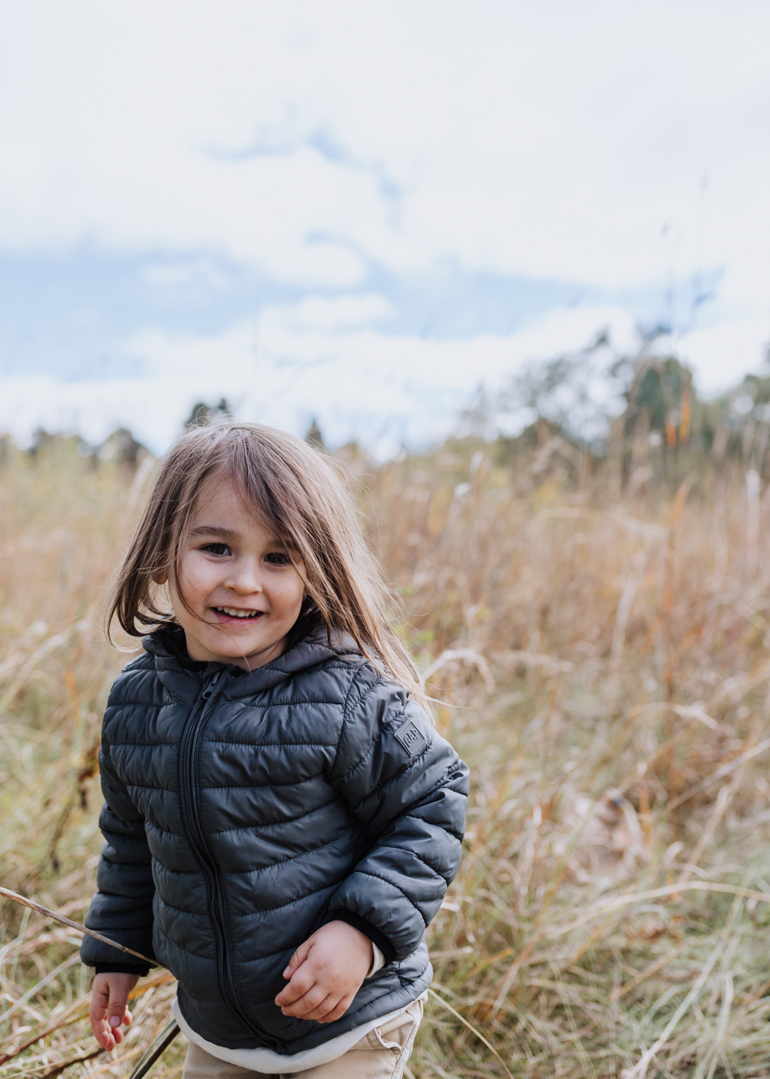 cutie pie in an open field in south dakota | thelovedesignedlife.com #fall #southdakota #childhood