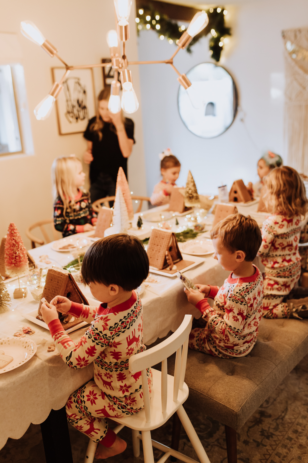 everyone ready to decorate their gingerbread houses and cookies at our simple party! | thelovedesigneldifecom #christmasjammies #gingerbreadshouses #christmaspartyidea #kidsparties