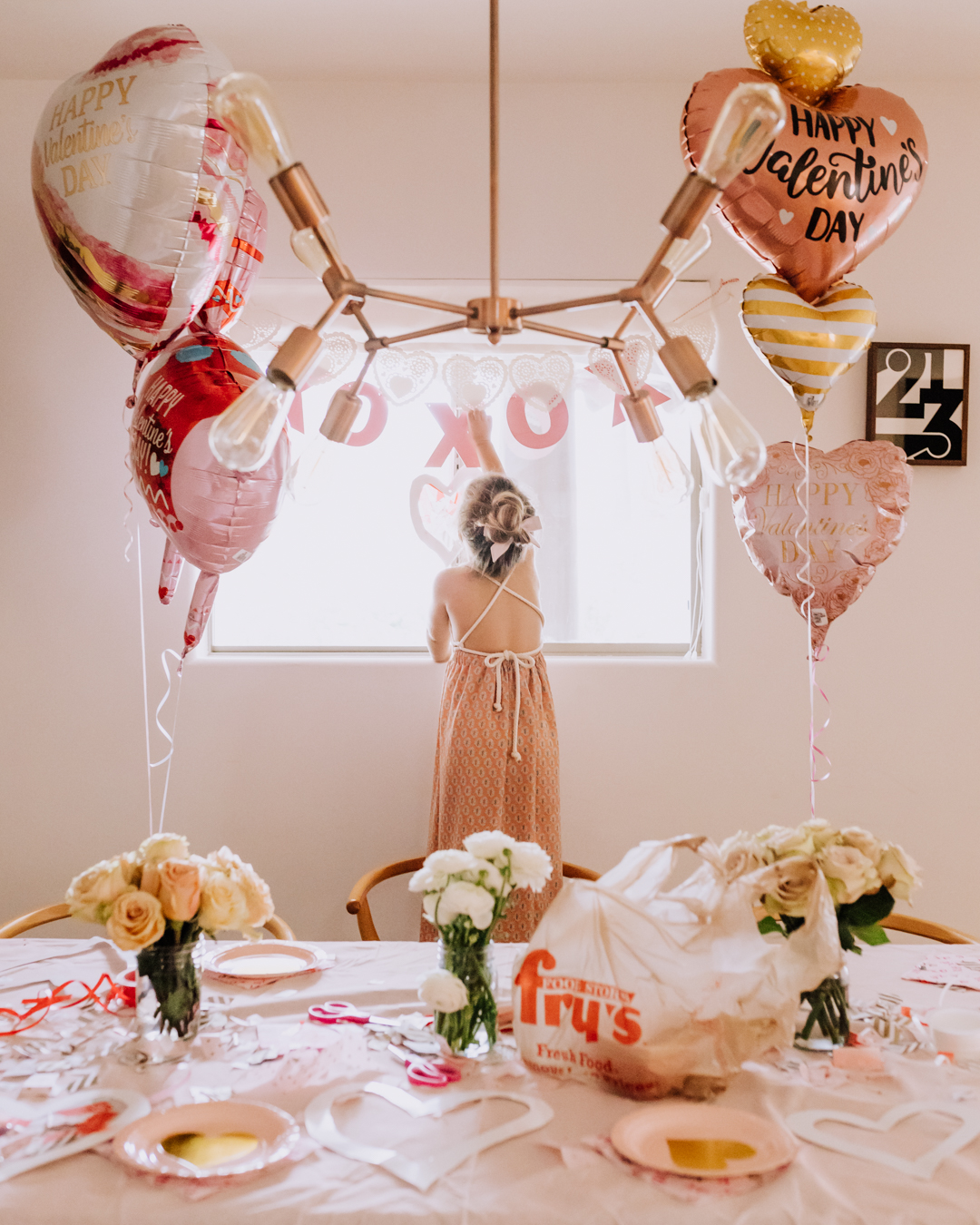 my sweet girl, helping set up for our valentine's day playdate | thelovedesignedlife.com #loveday #valentinesday #playdate #valentinescraft 