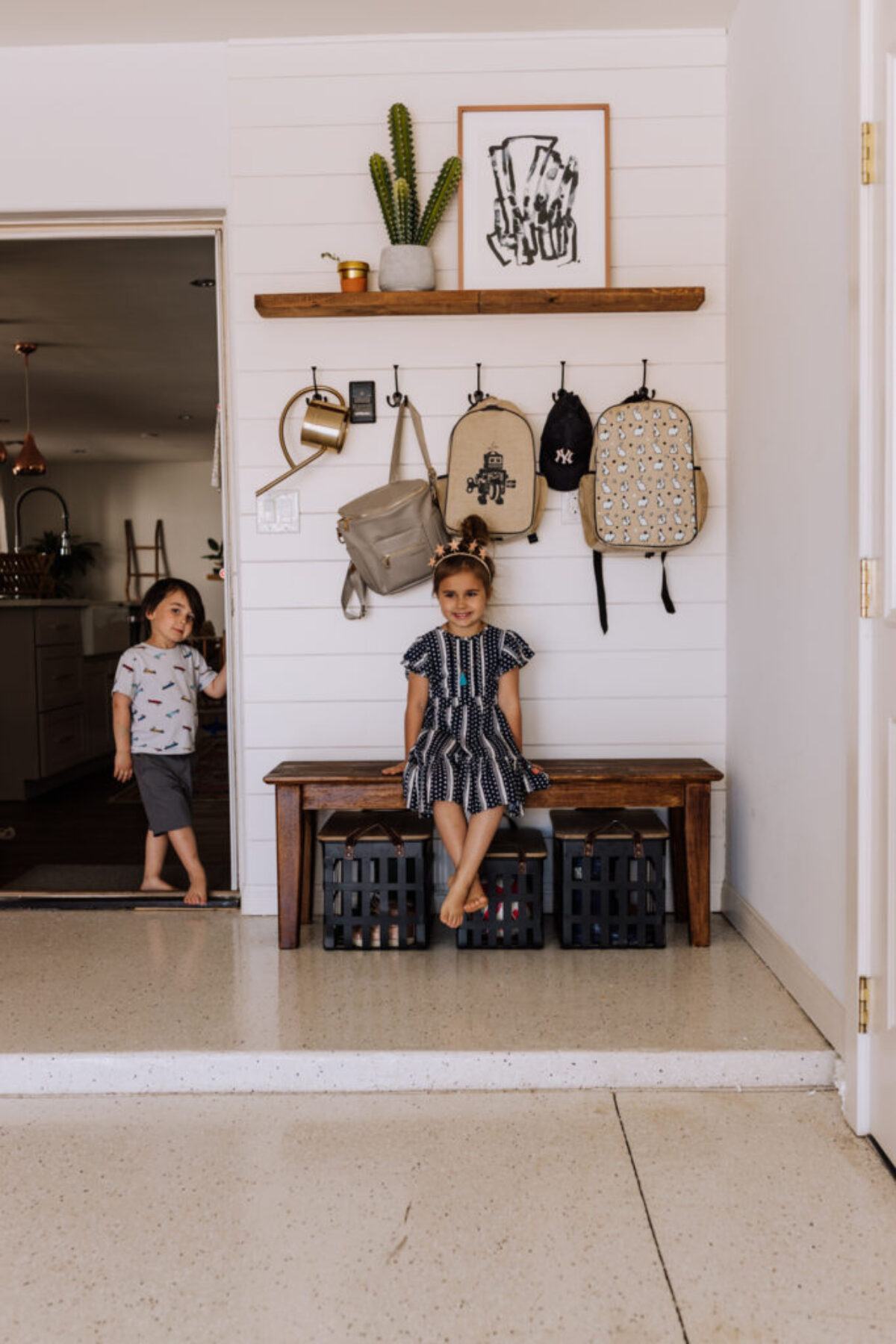coming home from school, the kids hang their backpacks in the garage | thelovedesignedlife.com #thedailymoments #home #garageorganization #interiordesign