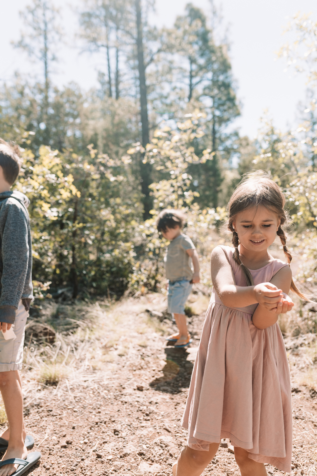 3 kids on a walk in the woods