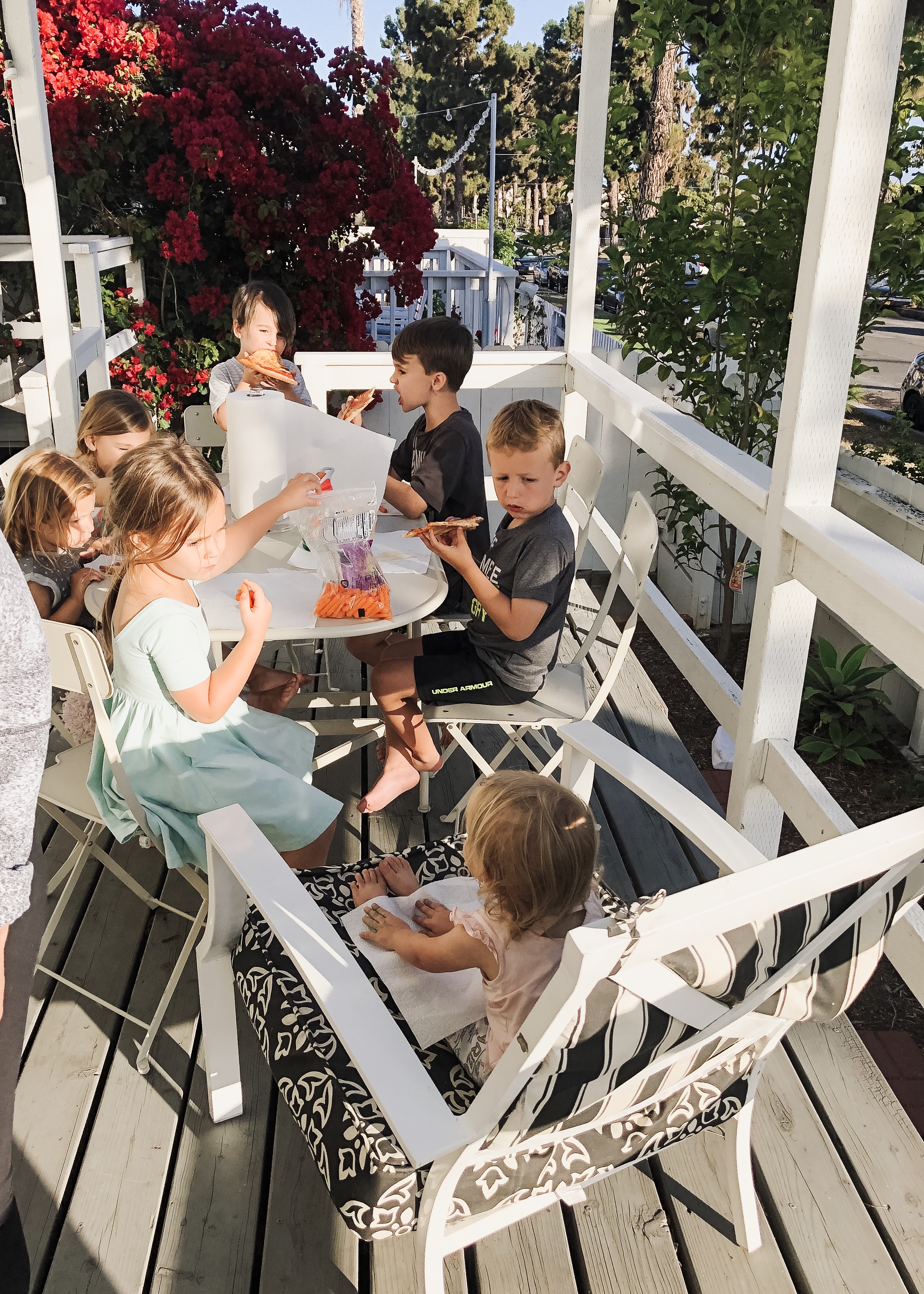 kids eating pizza on the porch