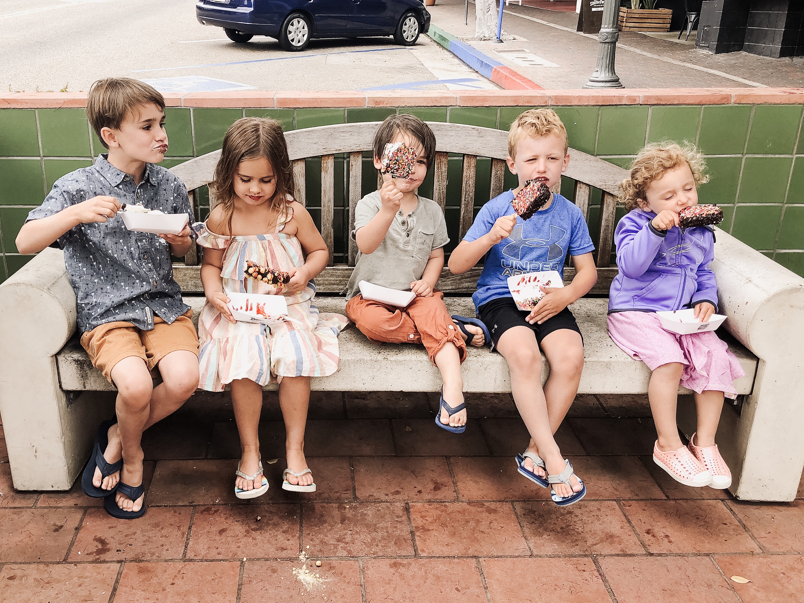 5 kids eating ice cream in a beach town, california