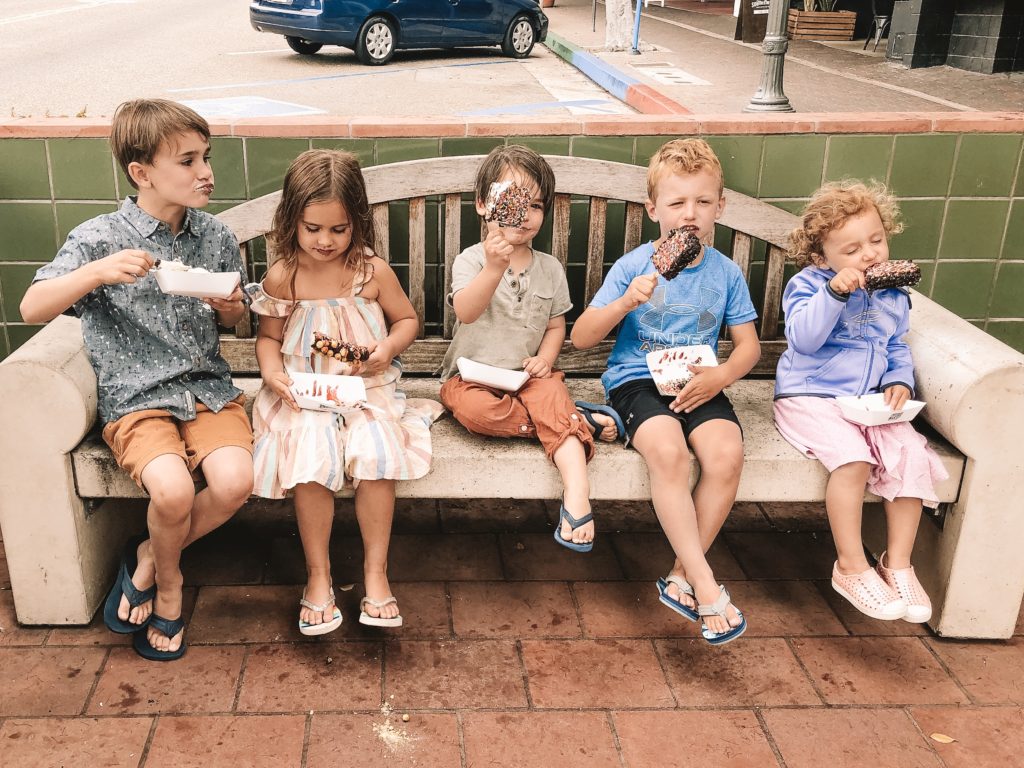 5 kids eating ice cream in a beach town, california