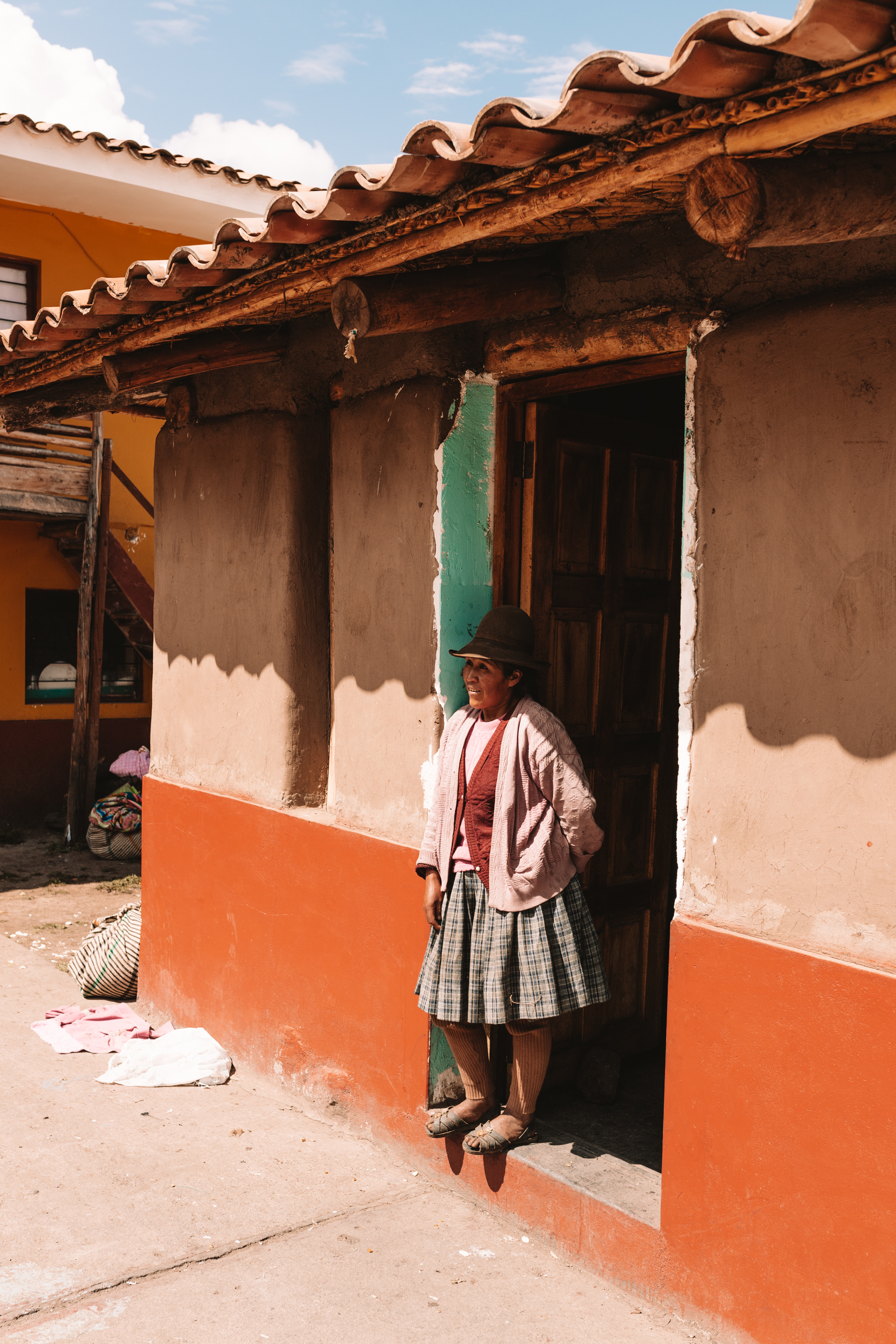 woman standing in a doorway in a traditional school in peru