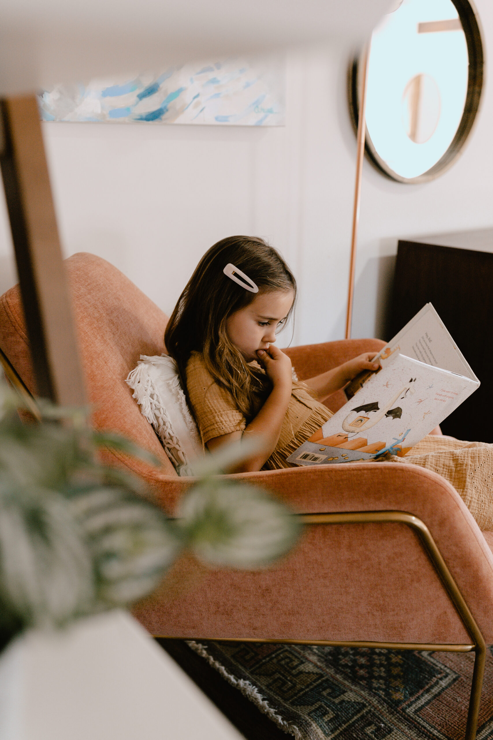 sweet girl reading in the pink forma chair from article #theldlhome #formachair #mybohoabode