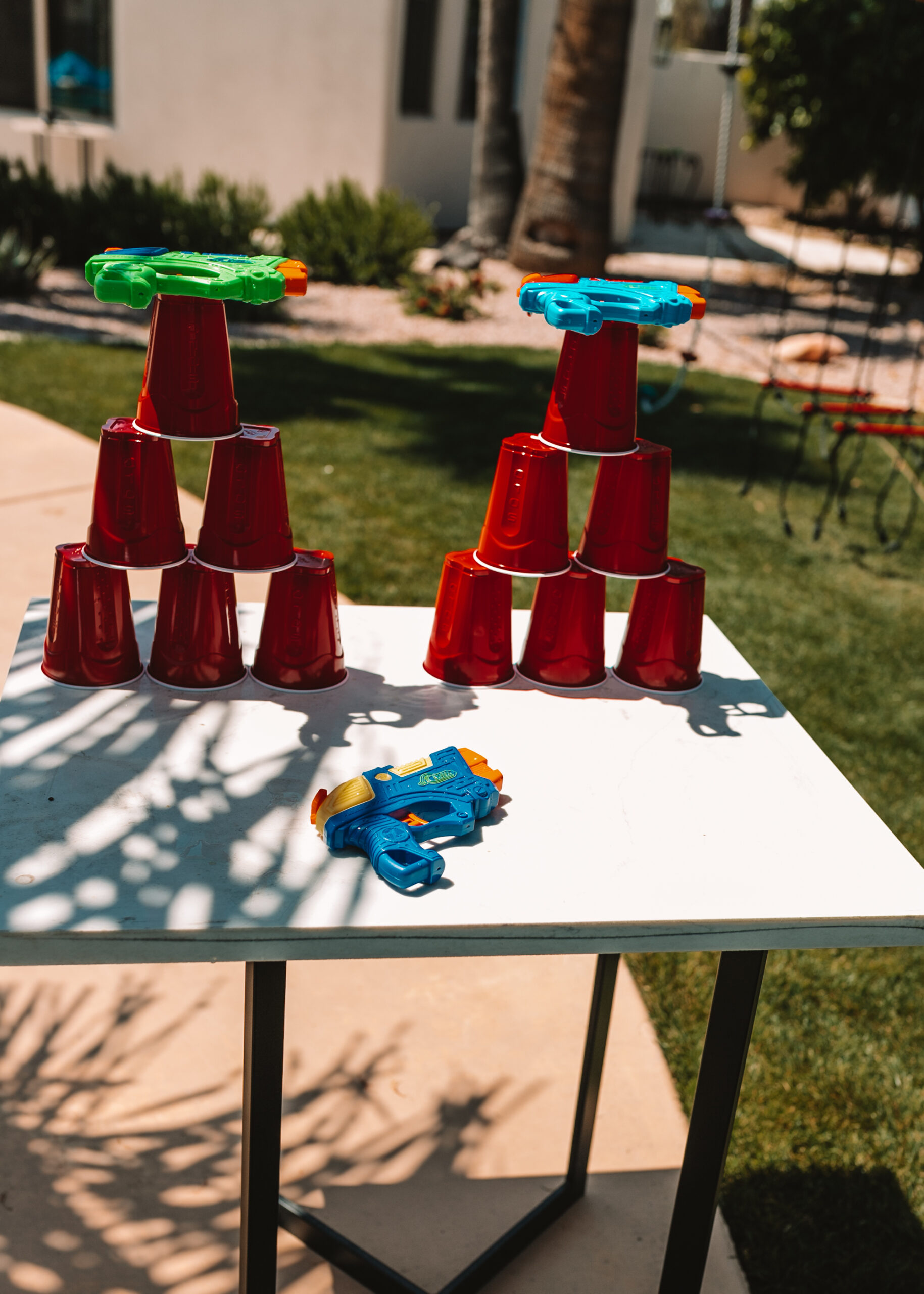 water gun cup tower shooting game. #outdoorfun #thelovedesigendlife #backyardwatergames