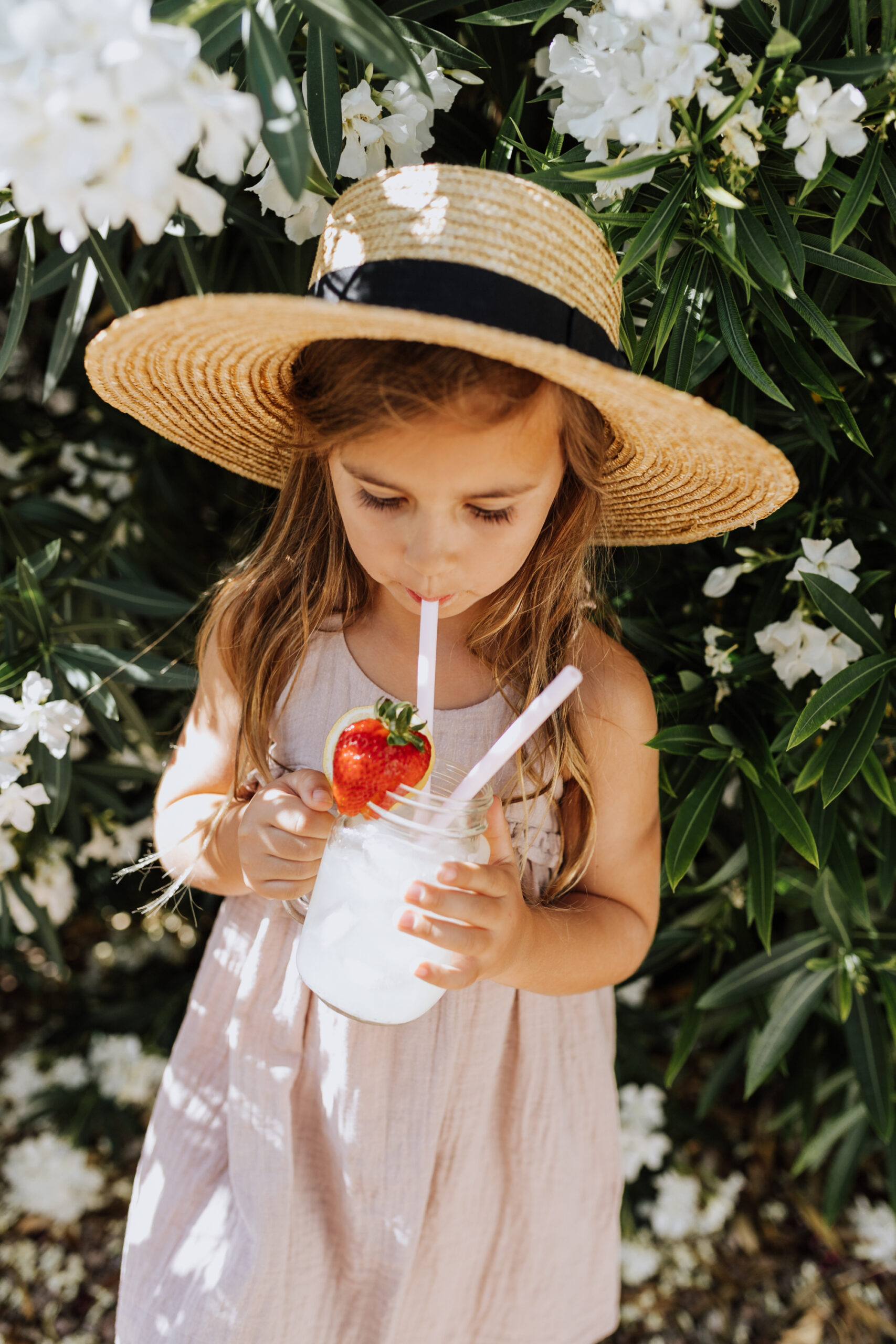 sipping lemonade in the springtime in our backyard with these reusable silicone straws from Grove. #sustainableswaps #reusablestraws #springtime #childhood #groveco