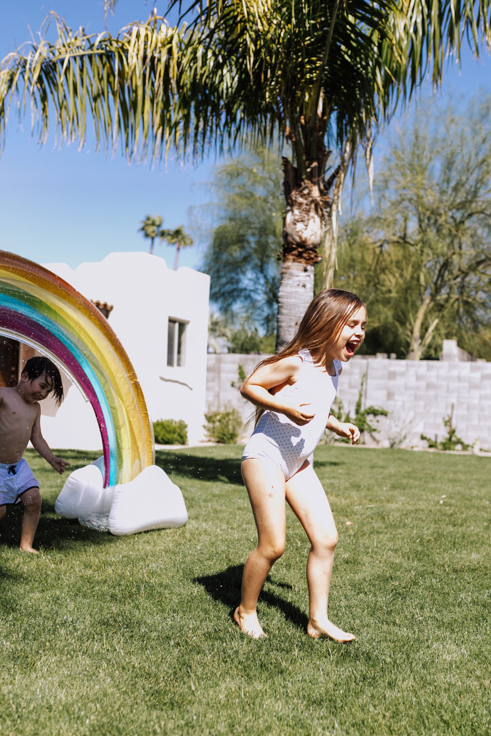 sunday funday in our backyard with the rainbow sprinkler! #backyardfun #childhoodfun