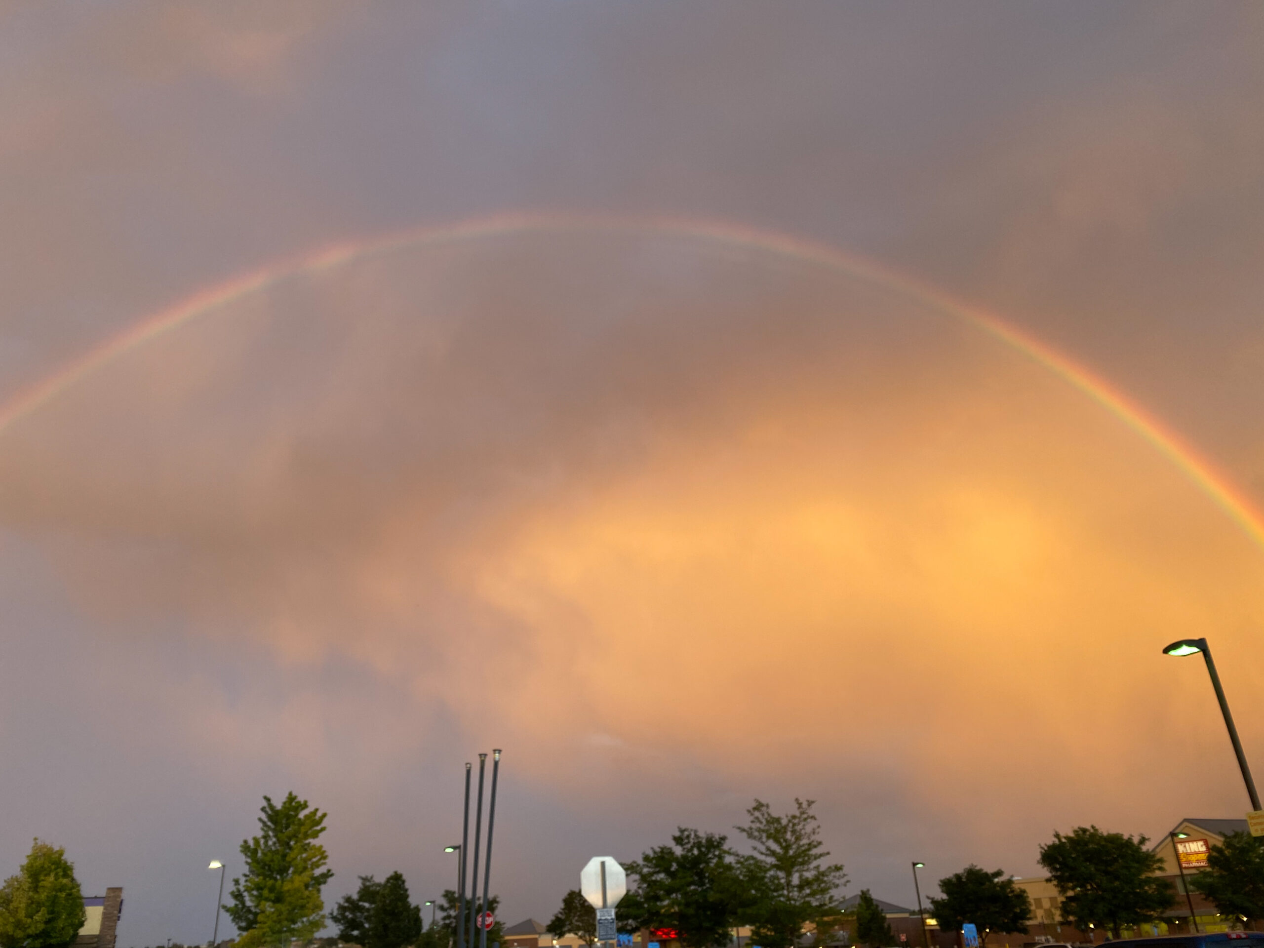 a full rainbow with a second one starting there in the corner of this golden sky! #coloradosummers #chasingrainbows