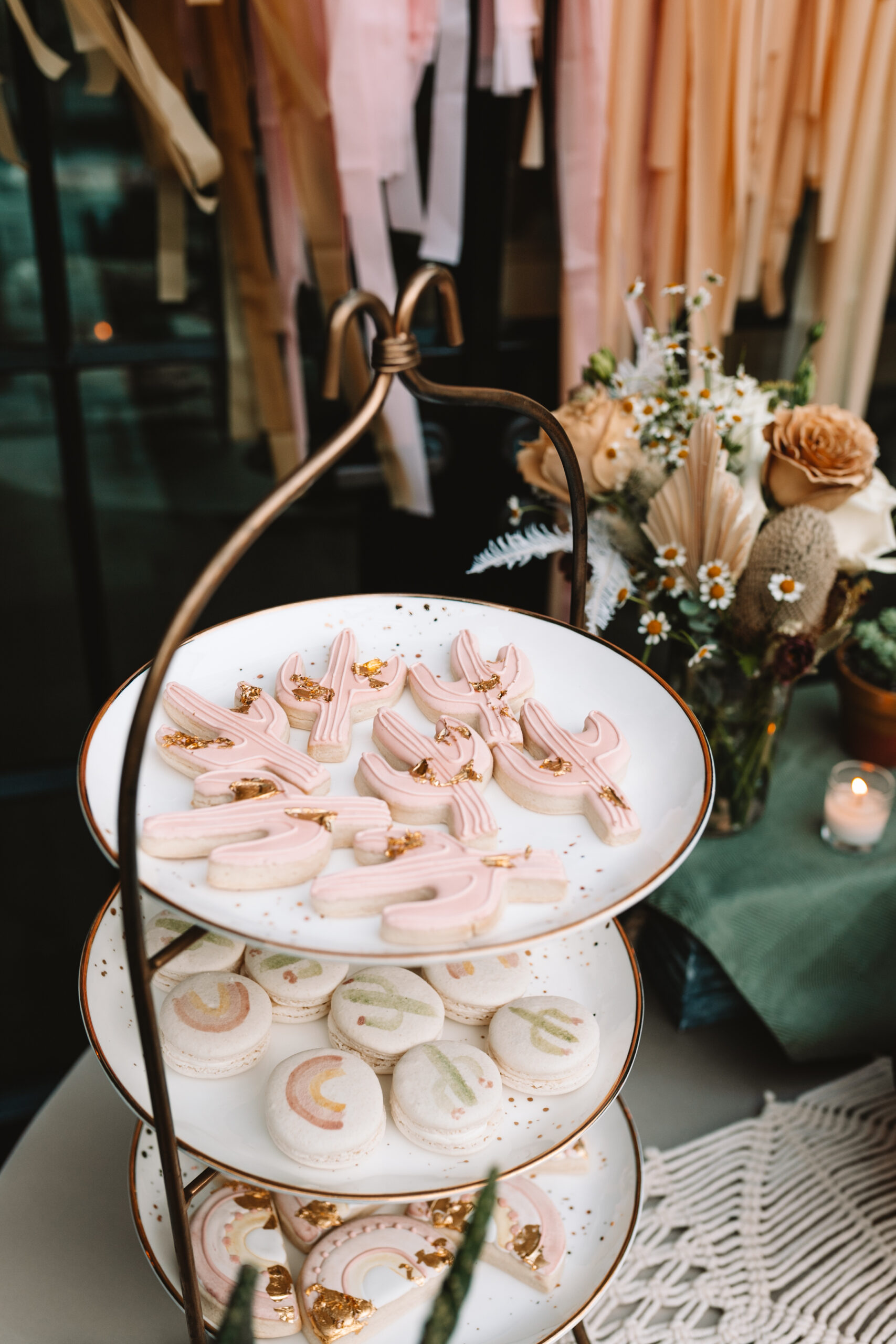 beautiful cactus cutout cookies and macaroons rom local phoenix bakery #abakeshop #cactuscookes #cactusmacaroons #desserttable #bohochicbabyshower