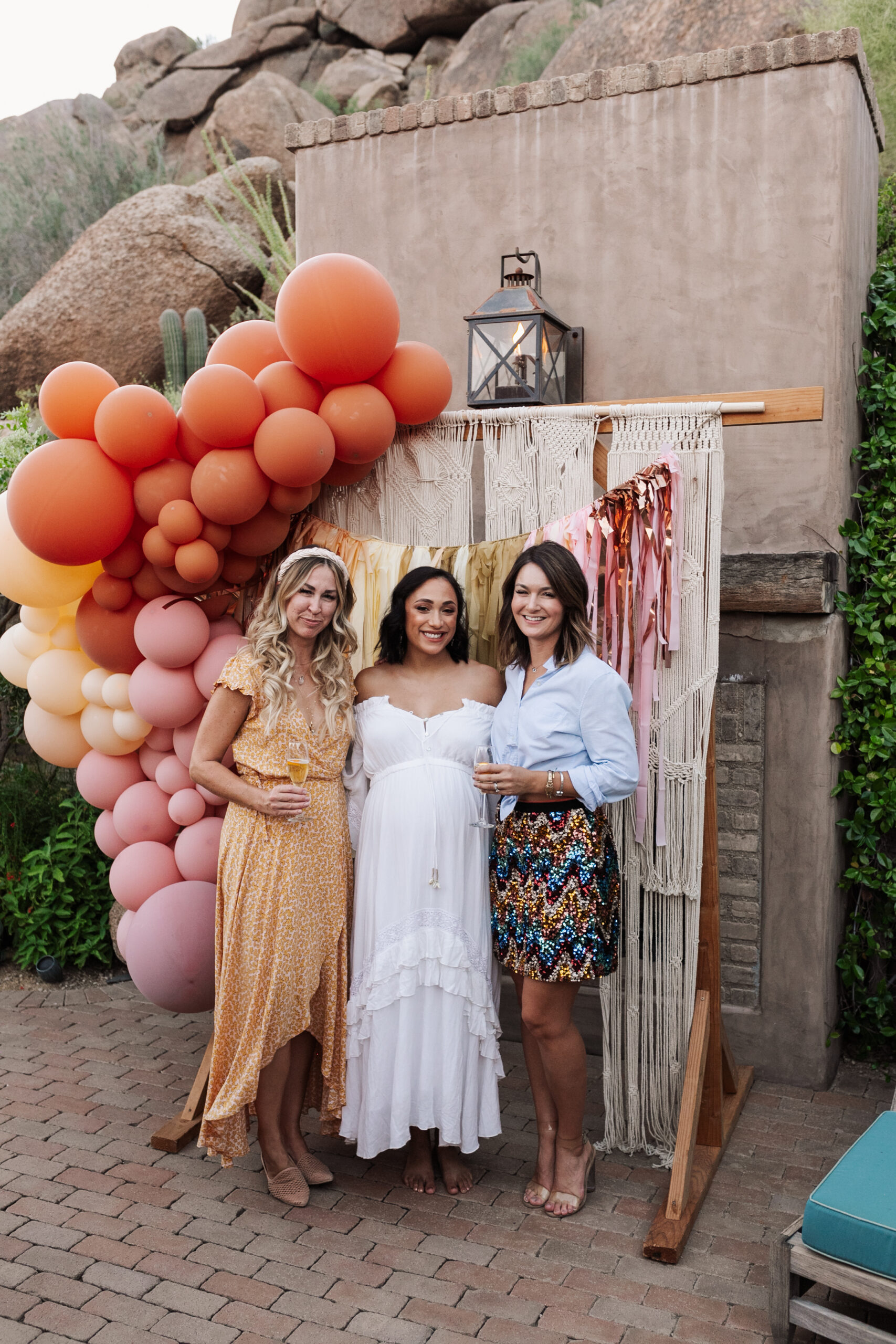 our mama to be and the party planners at this desert chic boho baby shower #partydesign #baloongarland #photobackdrop #babyshowerideas