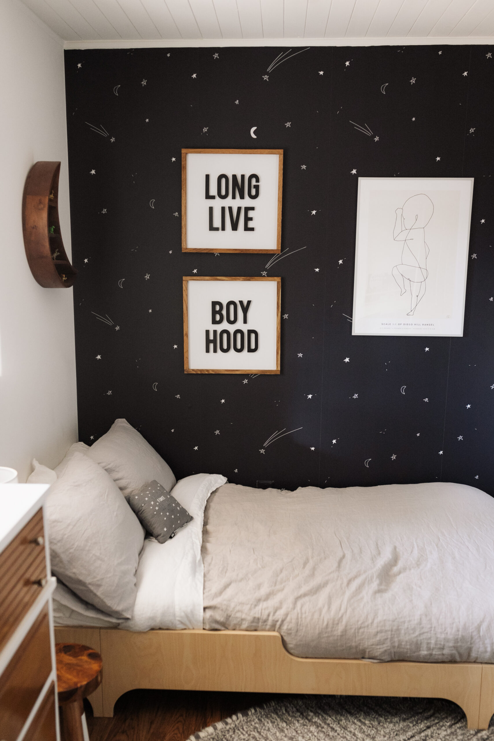 a space inspired bedroom for my big boy! I love how the wallpaper makes him feel like he is immersed in space, while cozy in his bedroom. #spaceinspiredbedroom #bigboyroom #boysbedroom #homedesign