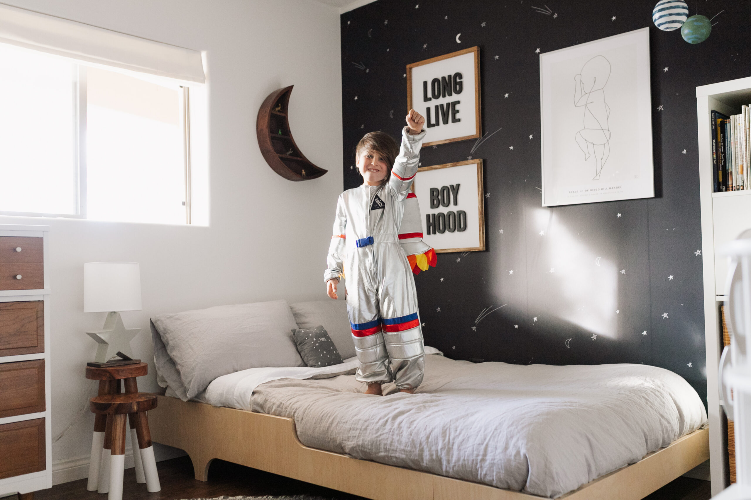 long live boyhood with this cute little future astronaut! blast off with his space inspired room details today on thelovedesignedlife.com #theldlhome #thelovedesignedlife #astronaut #kidsroom #bigboyroom