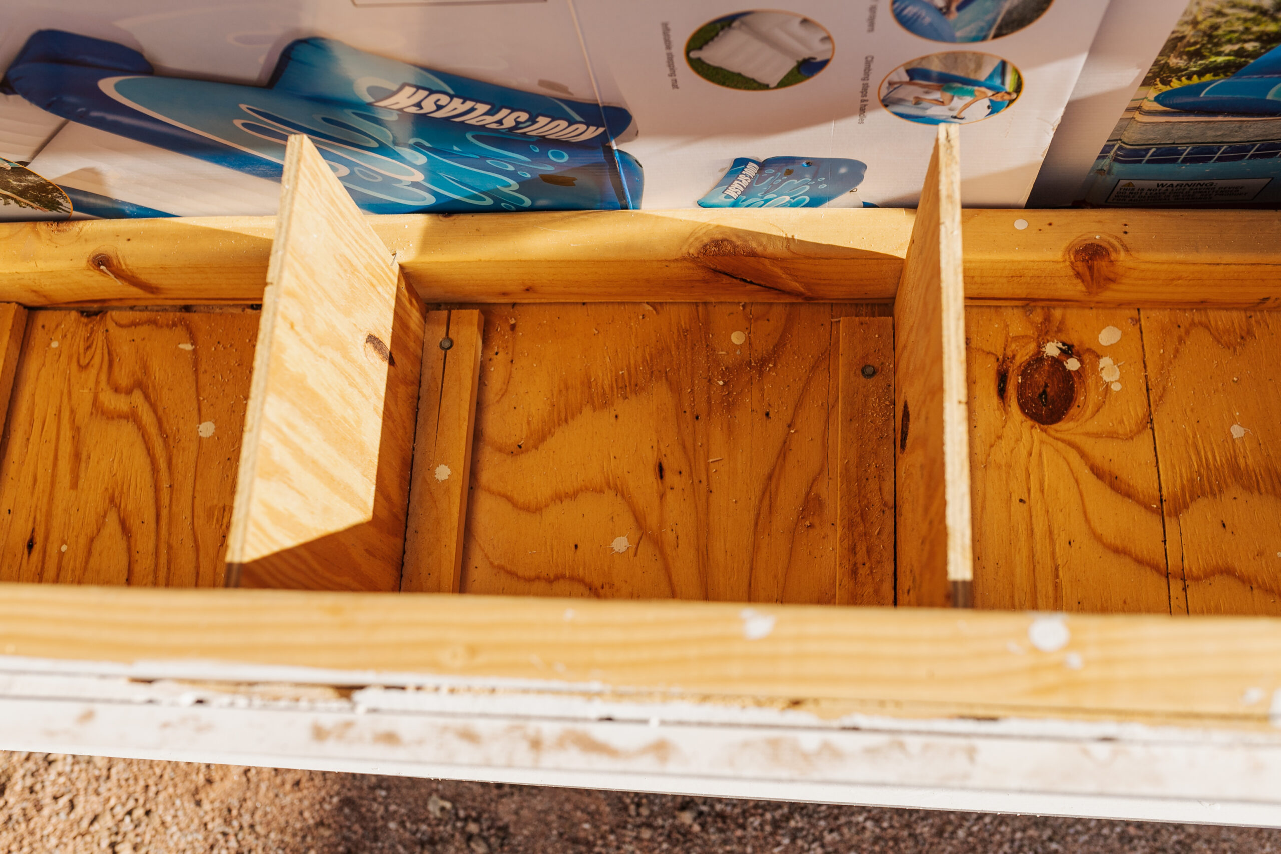 the inside of our nesting boxes, which are closed off with cardboard for now, until the chicks are old enough to start laying #thelovedesignedlife #nestingboxes #DIYchickencoop #backyardchickencoop