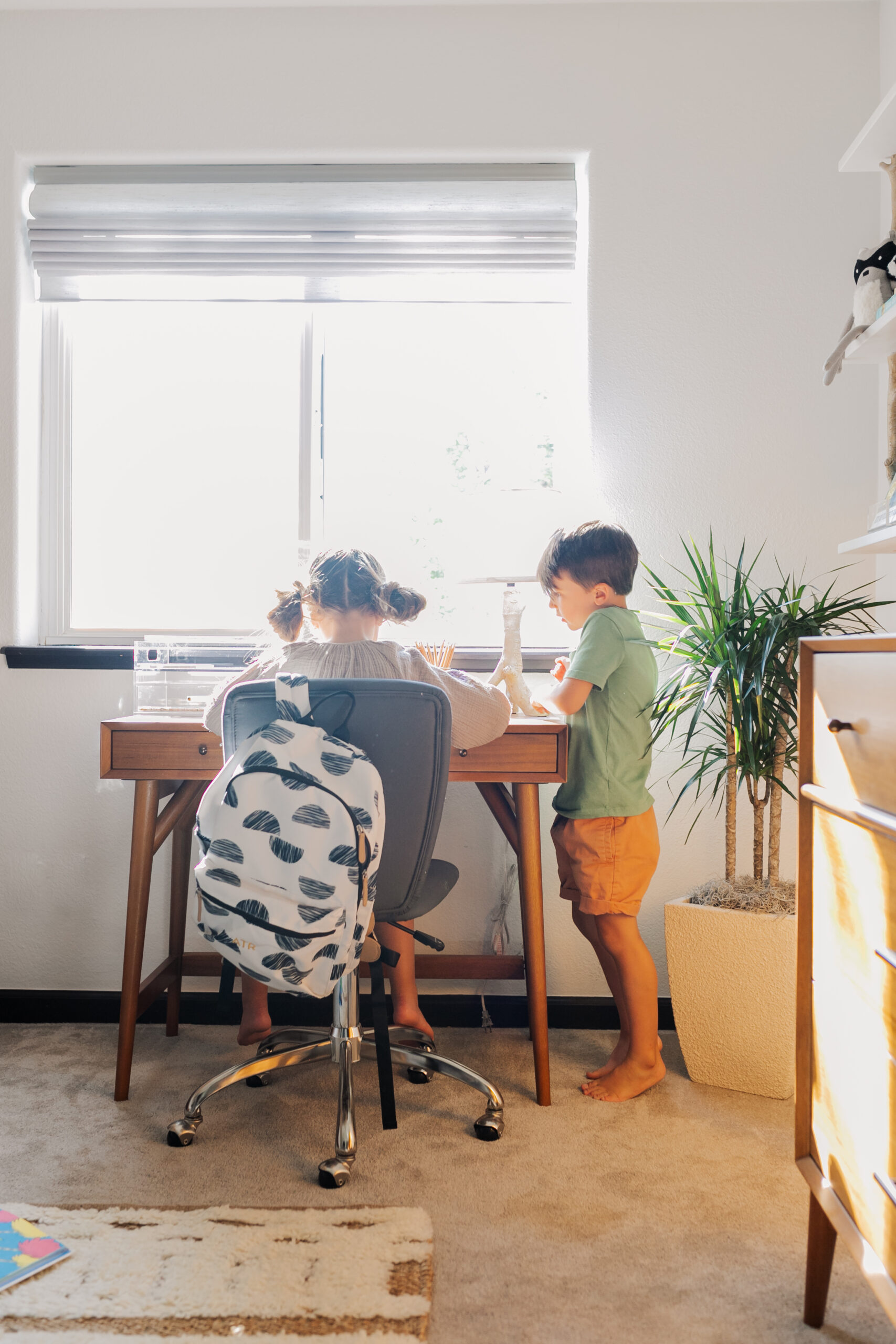 sweet siblings working on an art project together in this modern mountain bunk room #deskspace #kidsdesk #kidsroom #bunkroom #pbk #westelm #thelovedesignedlife