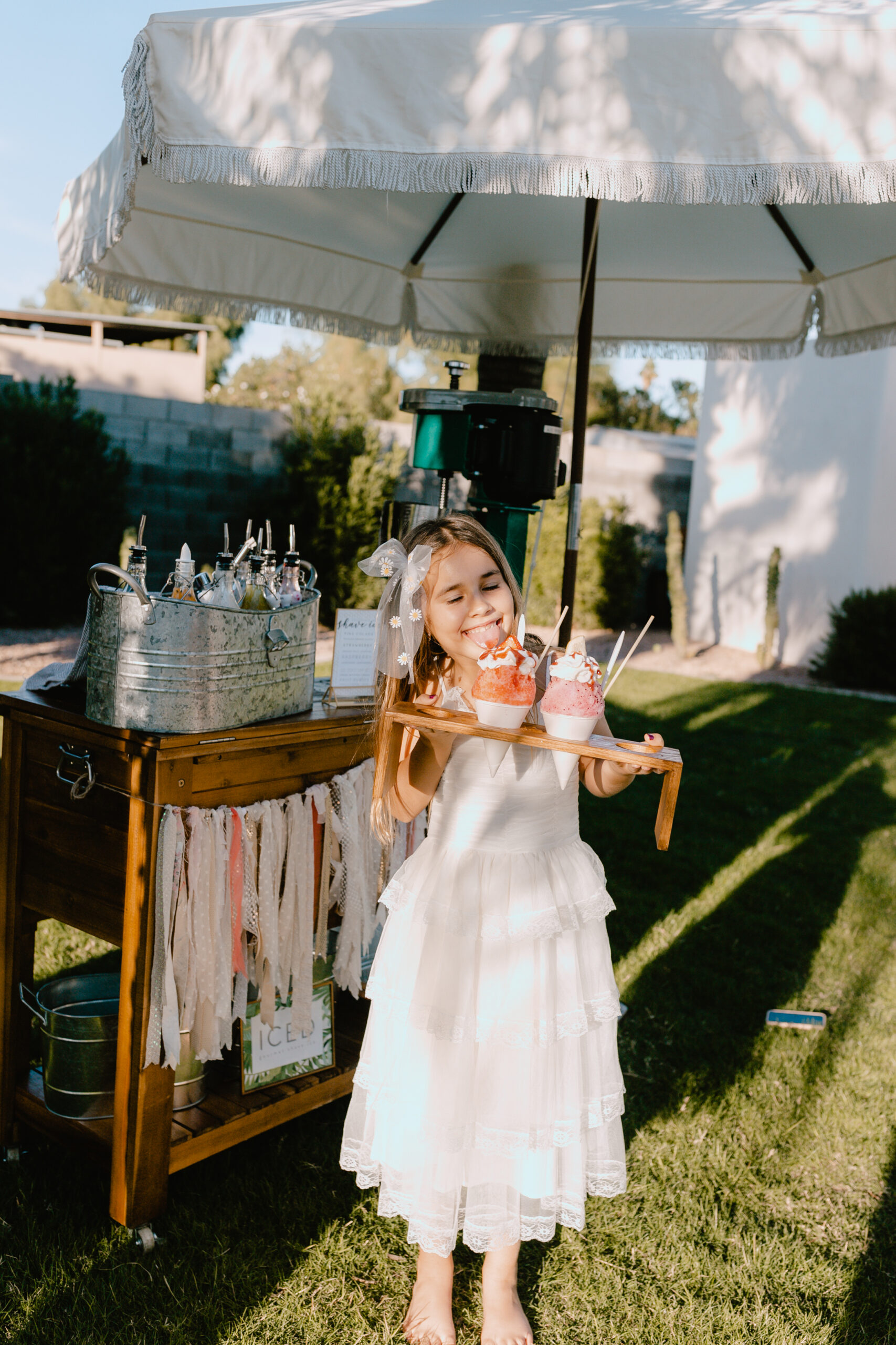 sweet girl standing in front of iced gourmet shaved ice for her 8th birthday