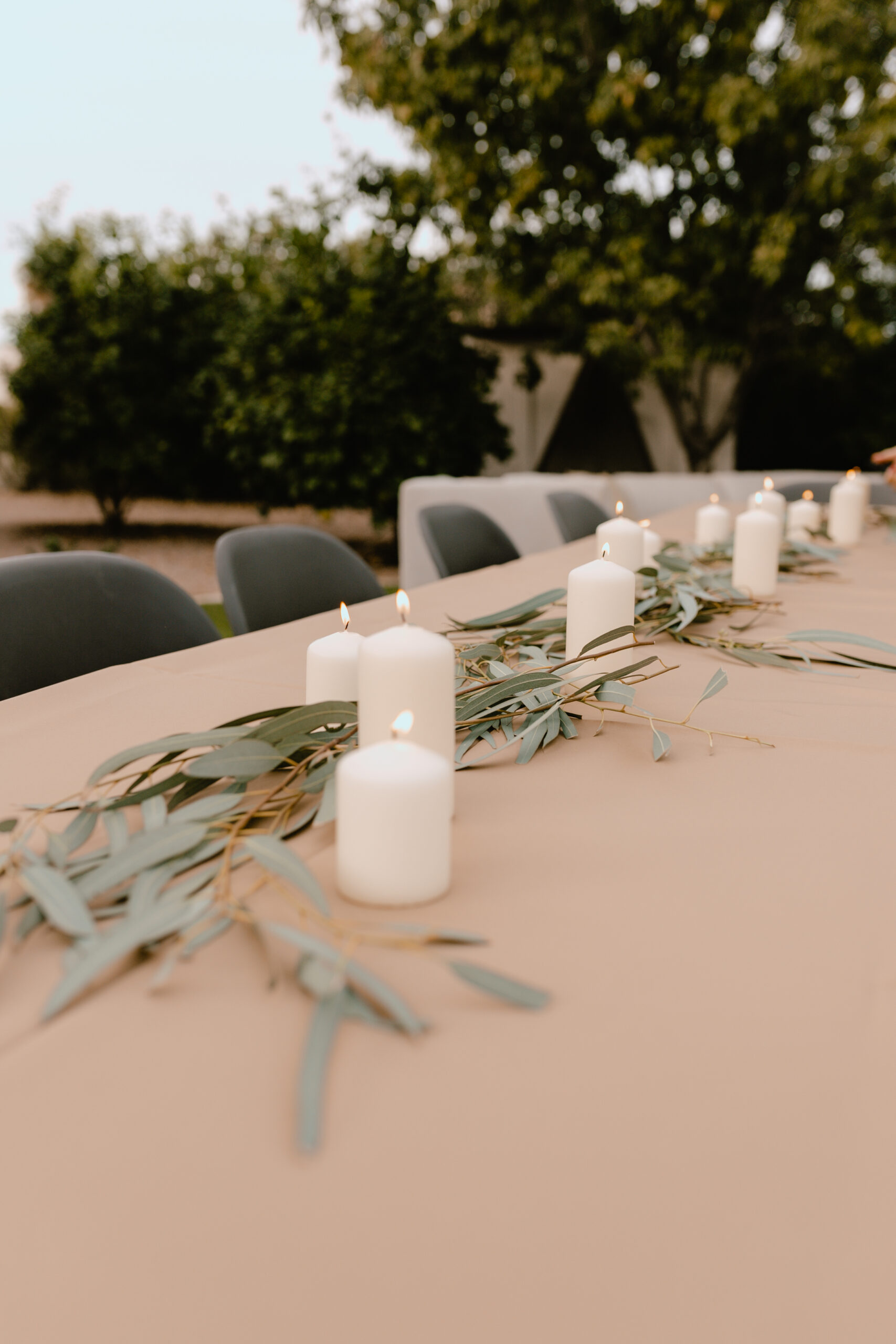 a simple tablescape of eucalyptus and candles #thelovedesignedlife #40thbirthdayparty #tablescape #theldlparties