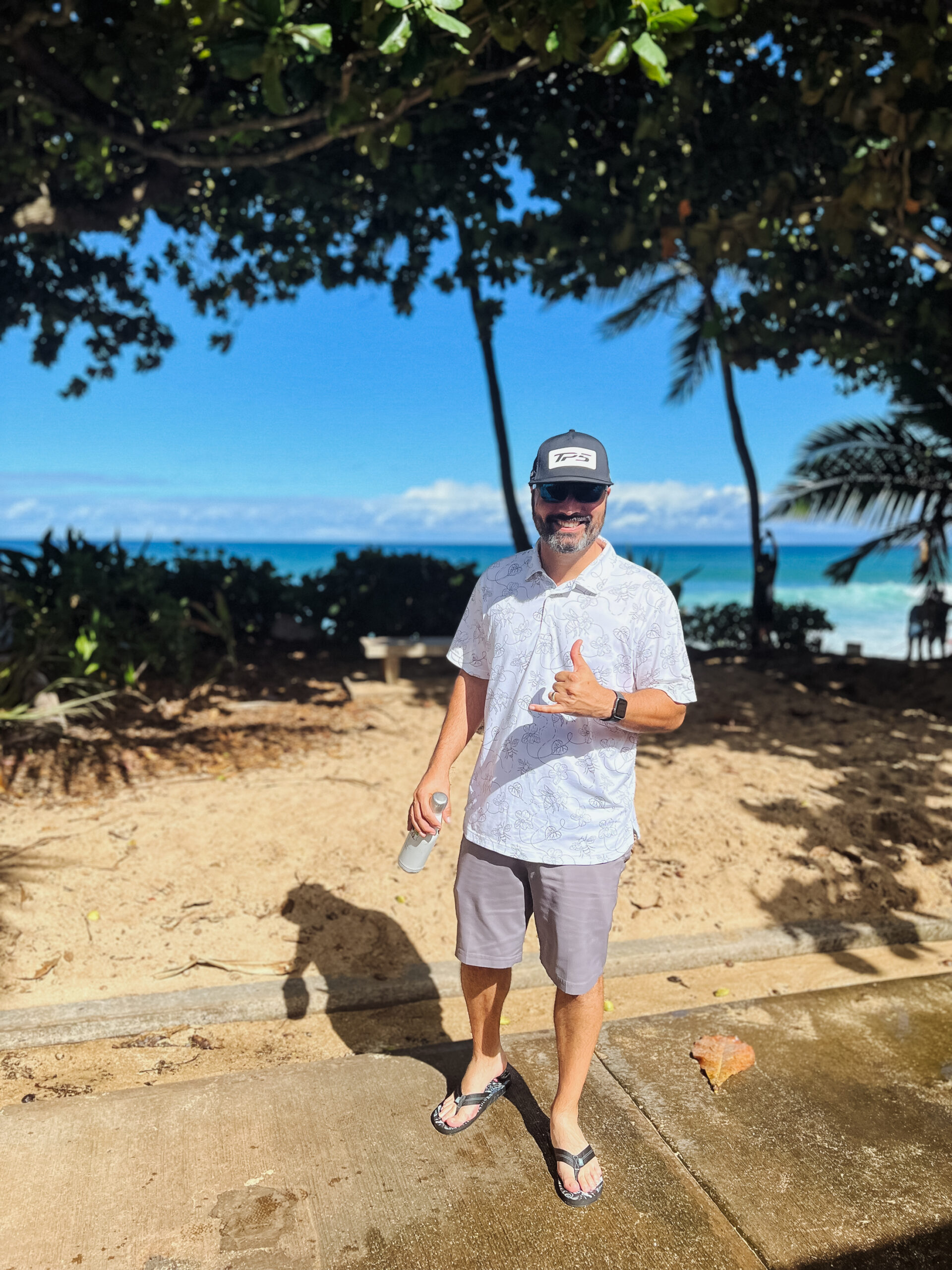 tony happily watching big waves and surfers on the north shore, oahu