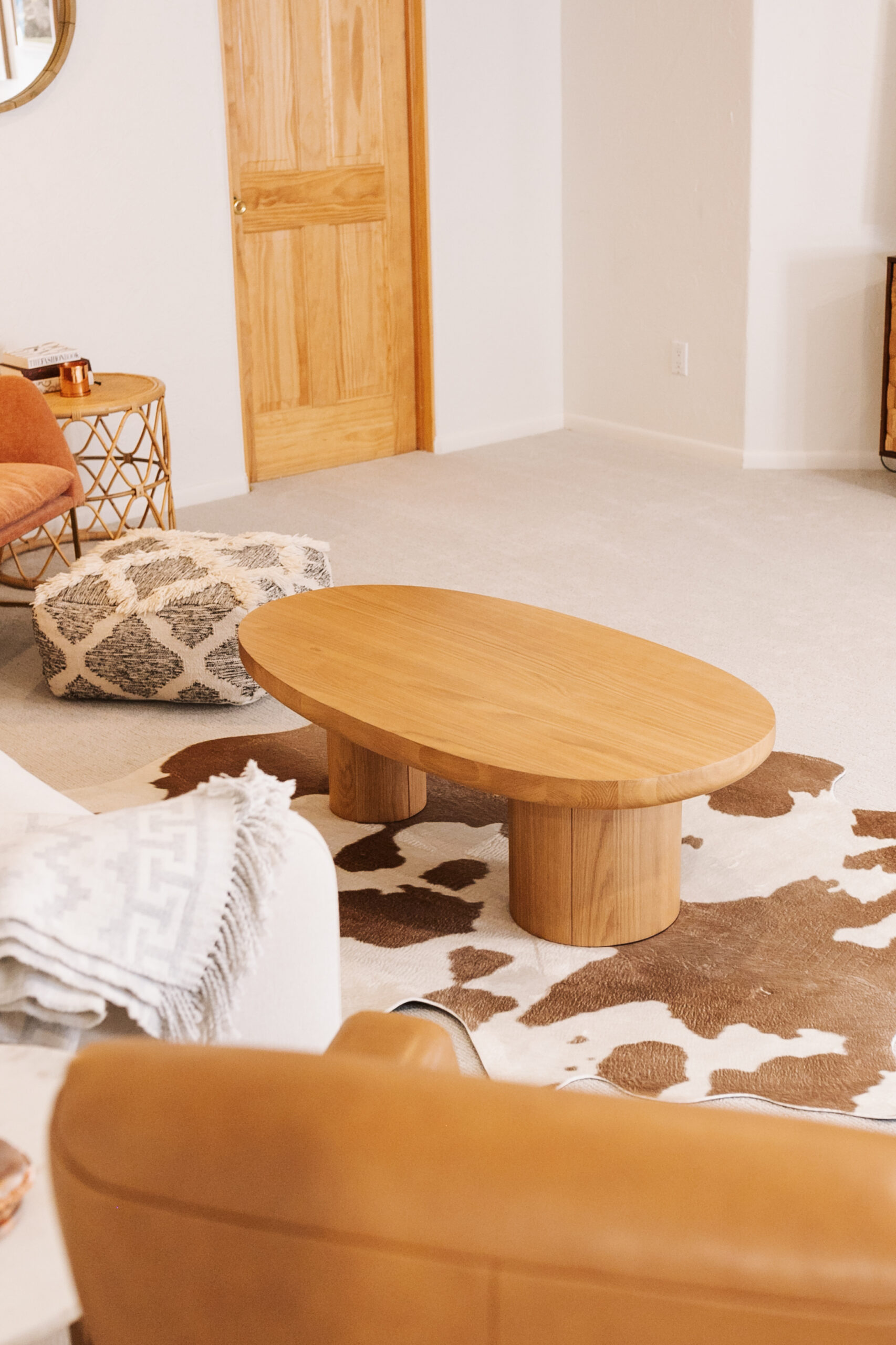 the soft curves of this solid oak Baarlo coffee table from Article is the perfect centerpiece to our cozy basement livingroom #theldlhome #habitandhome #ourarticle